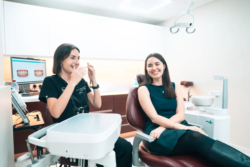 A patient chatting with her dentist in the surgery