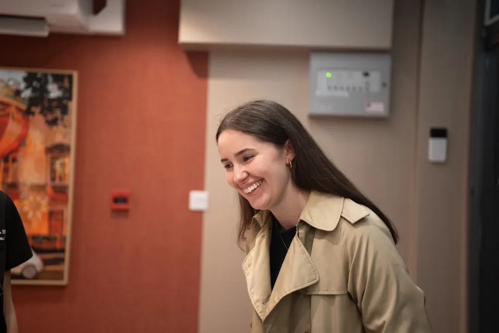 A patient smiling as she arrives at the Pearly Whites reception