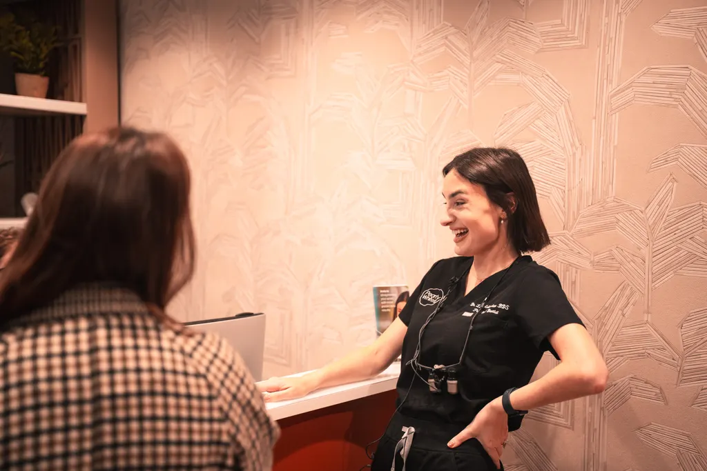 A patient chatting with the team at reception