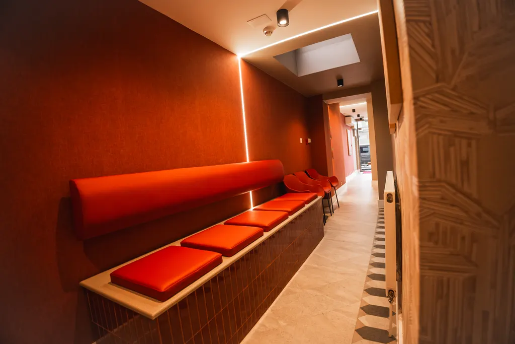 The practice corridor at Pearly Whites, with red banquette seating and warm lighting