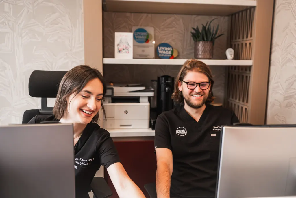 Dr Lia and Grant at the Pearly Whites reception desk