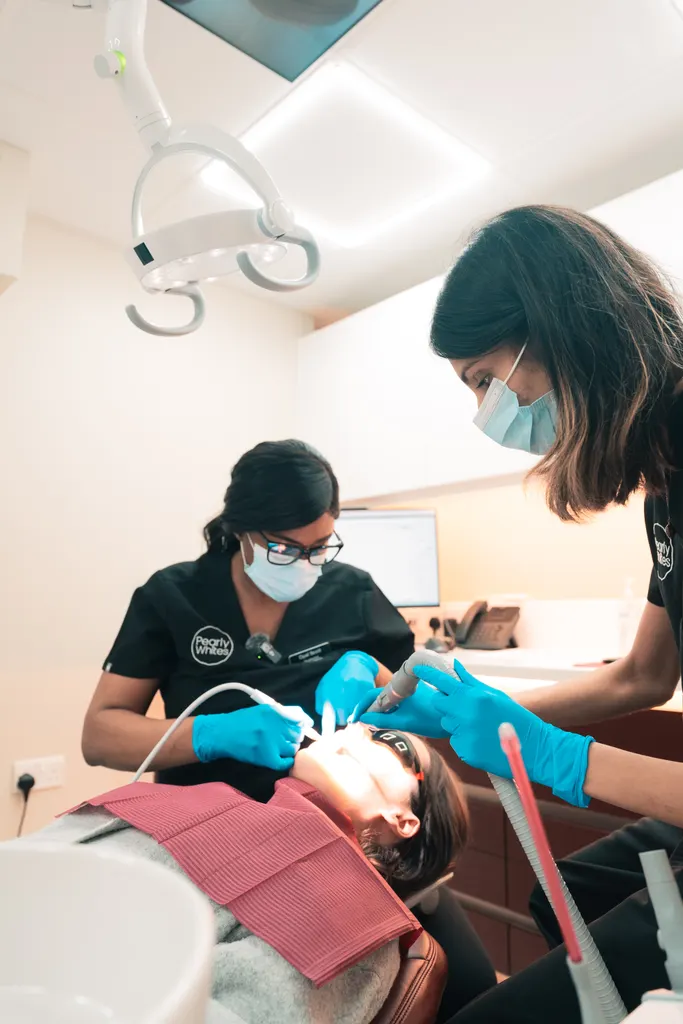 A Pearly Whites hygienist during a Guided Biofilm Therapy appointment