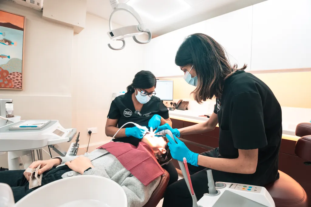A Pearly Whites hygienist and nurse treating a patient