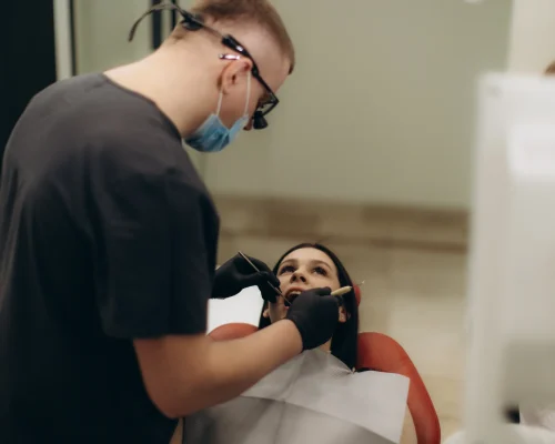 dentist-performing-a-dental-examination-on-a-patie-2026-01-09-10-14-35-utc